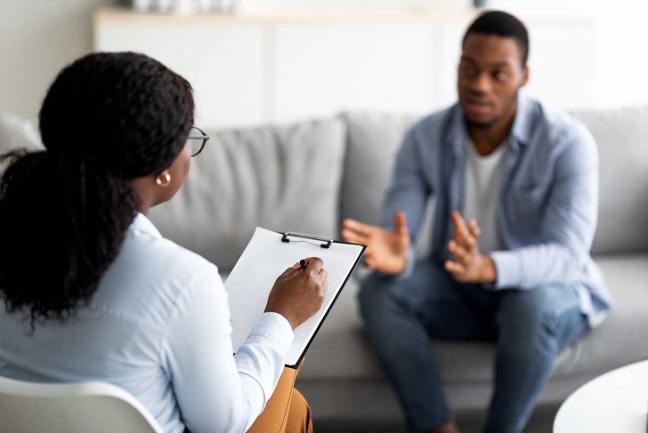 Psychological assistance. Millennial black man with depression having counseling session with therapist at office. Desperate young guy with emotional problem receiving help from psychiatrist at clinic