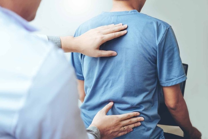 Doctor consulting with patient Back problems Physical therapy concept