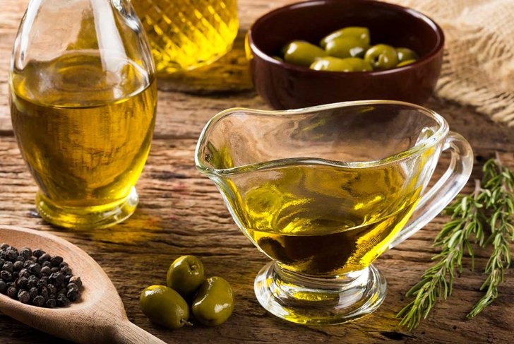 Olive oil. Containers with virgin olive oil and olives.