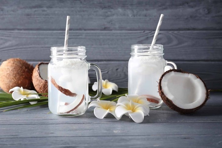 Beautiful composition with coconut water on table