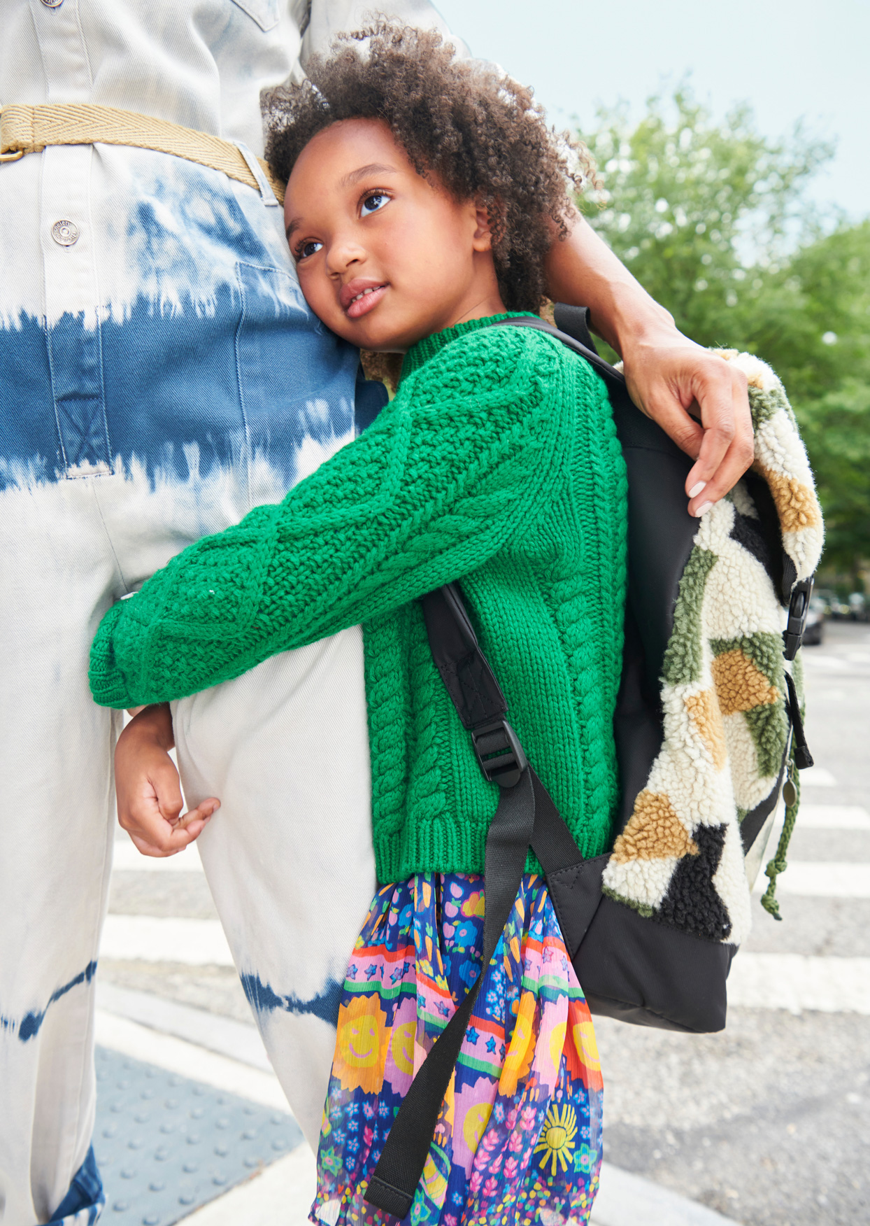 child hugging mothers leg